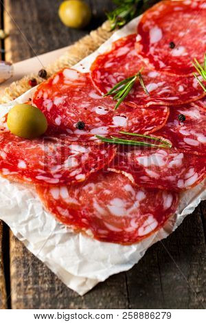 Chorizo Sausage And Salami, Thin Cut. Spanish Salami On The Wood Background With Spices, Paprika, Pe