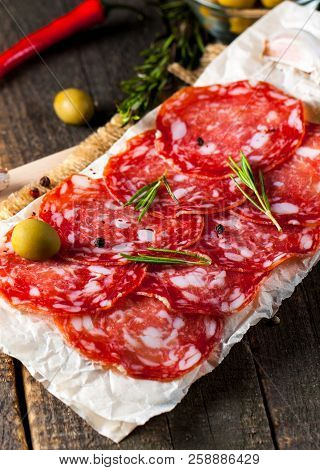 Chorizo Sausage And Salami, Thin Cut. Spanish Salami On The Wood Background With Spices, Paprika, Pe