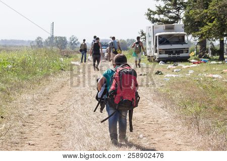 Tovarnik, Croatia - September 19, 2015: Young Refugee Child Carrying Heavy Backpack On The Croatia S