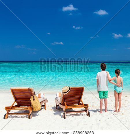 Kids brother and siter on a tropical beach during summer vacation