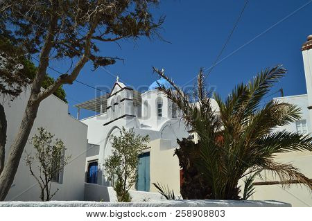 Bell Tower And Main Facade Of The Beautiful Church Of Pyrgos Kallistis On The Island Of Santorini. T