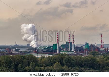 Coal Processing Plant Operates On The River Bank. The Smoke From The Pipes Pollutes The Atmosphere O