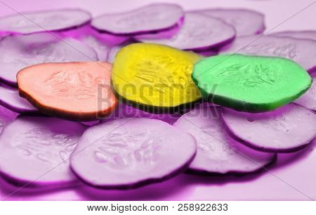 Cucumber Slices Texture Background. Fresh Cucumbers Diet Dish. Pink Background. Multi-colored Cucumb