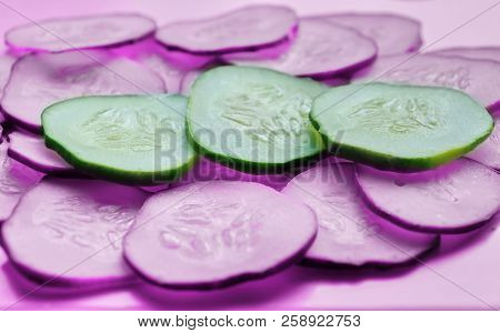 Cucumber Slices Texture Background. Fresh Cucumbers Diet Dish. Pink Background