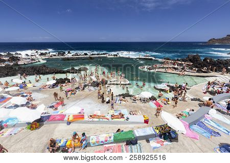 Porto Moniz, Portugal - August 7: Unidentified Tourists Swim In The Piscinas Naturais Or Natural Oce