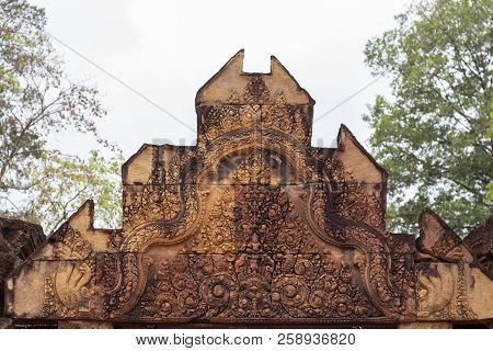 Stone Carved Bas-relief Of Banteay Srei Temple In Angkor Wat, Cambodia. Roof Portal With Floral Orna