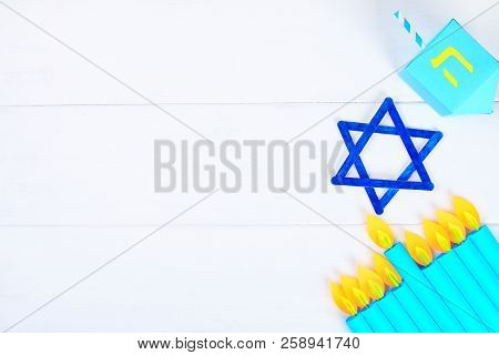 Menorah, Dreidel, Sevivon, The Star Of David With Their Own Hands On A White Wooden Table. Diy For A