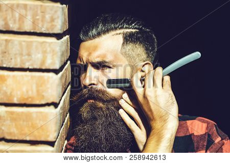 Young Man Brutal Hipster With Handsome Sexy Face Cutting His Fashion Long Beard And Moustache With C