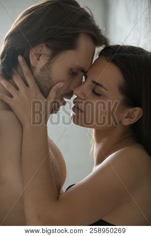 Sensual Millennial Couple Passionately Kissing Near Wall