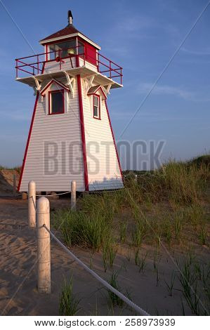 A Beach View Of The Covehead Harbour Lighthouse At Sunset Pei