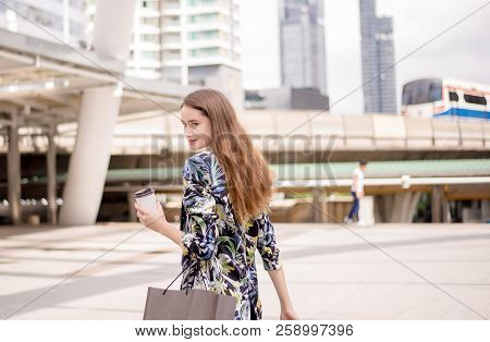 Portrait Of Beautiful Woman Smling And Holding Shopping Bags In City,lifestyle Concept