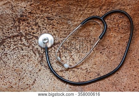 Medical Stethoscope On Cork Tree Background. Saving Nature And Humanity