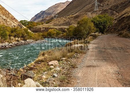 Mountain Road Along The Fast River, Kokemeren River, Jumgal District In Naryn Region Of Kyrgyzstan