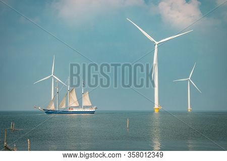 Wind Turbine From Aerial View, Drone View At Windpark Westermeerdijk A Windmill Farm In The Lake Ijs