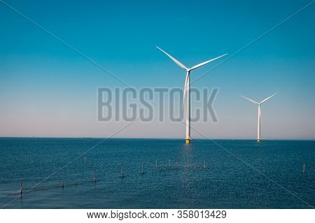 Wind Turbine From Aerial View, Drone View At Windpark Westermeerdijk A Windmill Farm In The Lake Ijs
