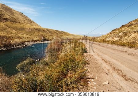 Mountain Road Along The Fast River, Kokemeren River, Jumgal District In Naryn Region Of Kyrgyzstan