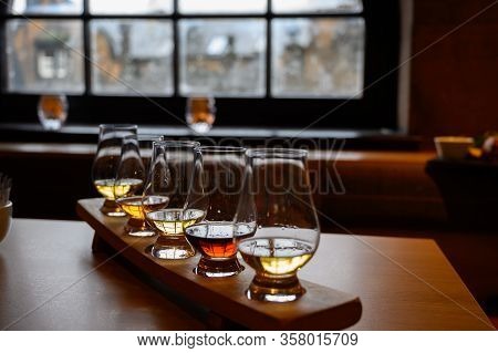 Flight Of Scottish Whisky, Tasting Glasses With Variety Of Single Malts Or Blended Whiskey Spirits O