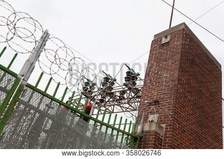 Angled View Of Power Substation Enclosure With Old Brick And Wrought Iron Security Enhanced With Mod