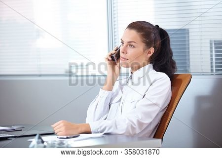 businesswoman with mobile phone in offece