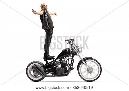 Bald punk daredevil standing on a chopper motorbike isolated on white background