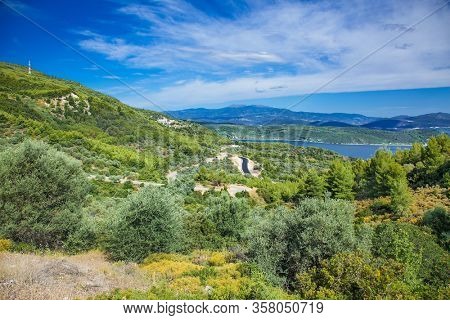 Panoramic view from above on the forests of Evia island  with the sea on the horizon on a sunny day. Evia . Greece. 