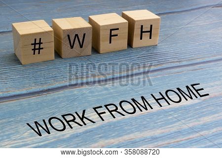 Concept Image A Wooden Block And Word - #wfh ( Work From Home ) On Wooden Background