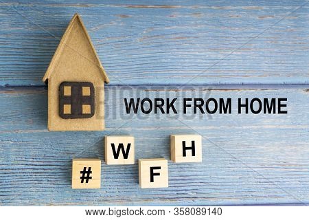Concept Image A Wooden Block And Word - #wfh ( Work From Home ) On Wooden Background