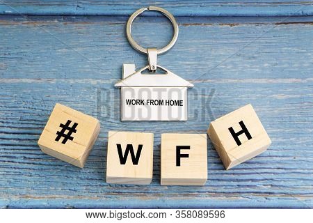 Concept Image A Wooden Block And Word - #wfh ( Work From Home ) On Wooden Background