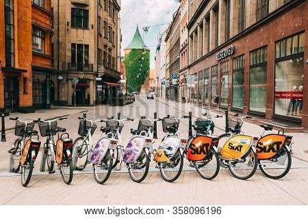 Riga, Latvia - July 2, 2016: Row Of Colorful Bicycles For Rent At Municipal Bike Parking In Kalku St
