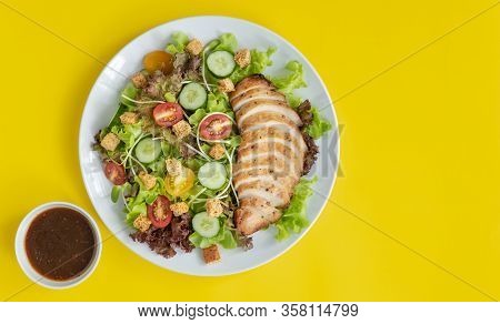 Top View Shot Of Chicken Salad Anad Sauce  With Several Kinds Of Fresh Vegetable In White Plate On Y
