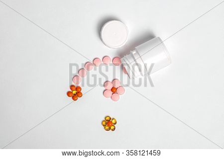White Plastic Bottle With Medicines And Vitamines. Tematic Health. Rose, Yellow And Red Medicines.