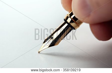 Fountain Pen In The Hand On The White Paper Closeup
