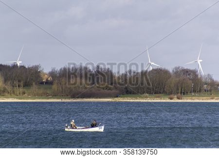 Fishermen In A Small Boat On Grafham Water Reservoir, Cambridgeshire, England