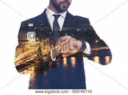 Double Exposure Of Businessman Checking Time And Night City Landscape