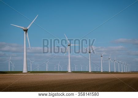 Offshore Windmill Farm In The Ocean Westermeerwind Park , Windmills Isolated At Sea On A Beautiful B