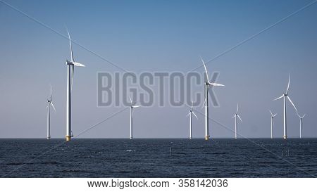 Offshore Windmill Farm In The Ocean Westermeerwind Park , Windmills Isolated At Sea On A Beautiful B