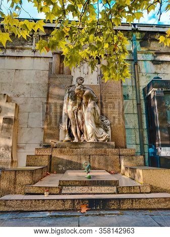 Old Grave With A Monument To A Famous Person In The Cemetery. Architectural Stone Statue In The Gard