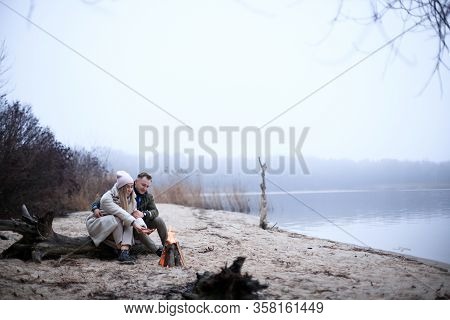 Winter Picnic On Baech With Bonfire. Love Story On Winter Foggy Sand Beach. Valentines Concept.