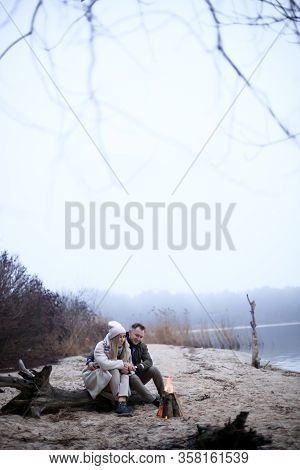 Winter Picnic On Baech With Bonfire. Love Story On Winter Foggy Sand Beach. Valentines Concept.