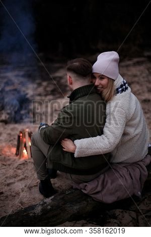 Winter Picnic On Baech With Bonfire. Love Story On Winter Foggy Sand Beach. Fry Marshmallows At The 