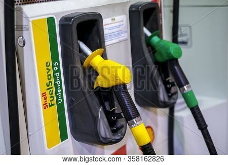 Petrol Pump Filling Nozzles At Shell Gas Station