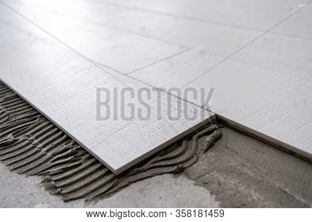 Ceramic wood effect tiles and tools for tiler on the floor  unfinished laying floor tiles  Floor tiles installation