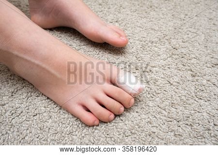 Kid Teenager Bare Foot With A Bandage On A Toe, Wounded Toe Or Ingrown Nail First Aid.