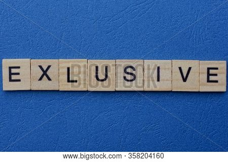 Word Exlusive Made From Gray Letters Lies On A Blue Background