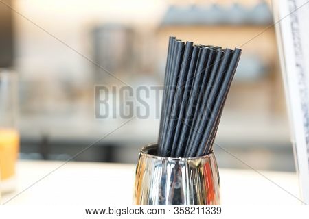 Black Paper Straw In The Stainless Cup At The Restaurant Bar. It's The Choice For Reduce The Plastic
