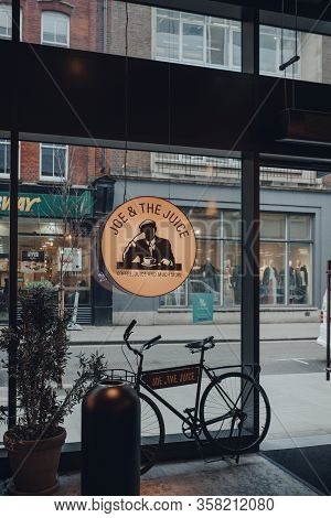 London, Uk - March 06, 2020: Bike By The Sign Inside Joe & The Juice Cafe In Soho, London. Joe & The