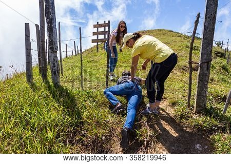 Olan, Costa Rica  - January 15 2020: People Crawling Under A Barbed Wire Fence In Rural Costa Rica, 
