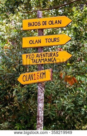 Olan, Costa Rica  - January 15 2020: Bright Yellow Sign In The Countryside With Directions To Tour G