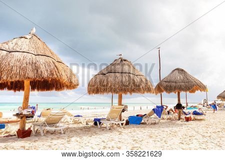 Unrecognizable Beachgoers Flock To The Tropical Beaches Of Riviera Maya Near Cancun, Mexico, During 