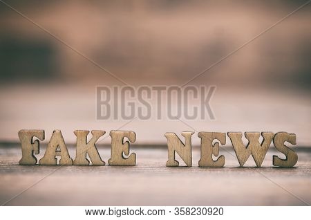 Fake News Wooden Letters On A Wooden Background. Fake News As A Form Of News Consisting Of Deliberat